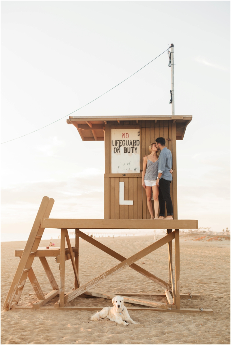  Couple kissing on lifeguard stand in Newport Beach 