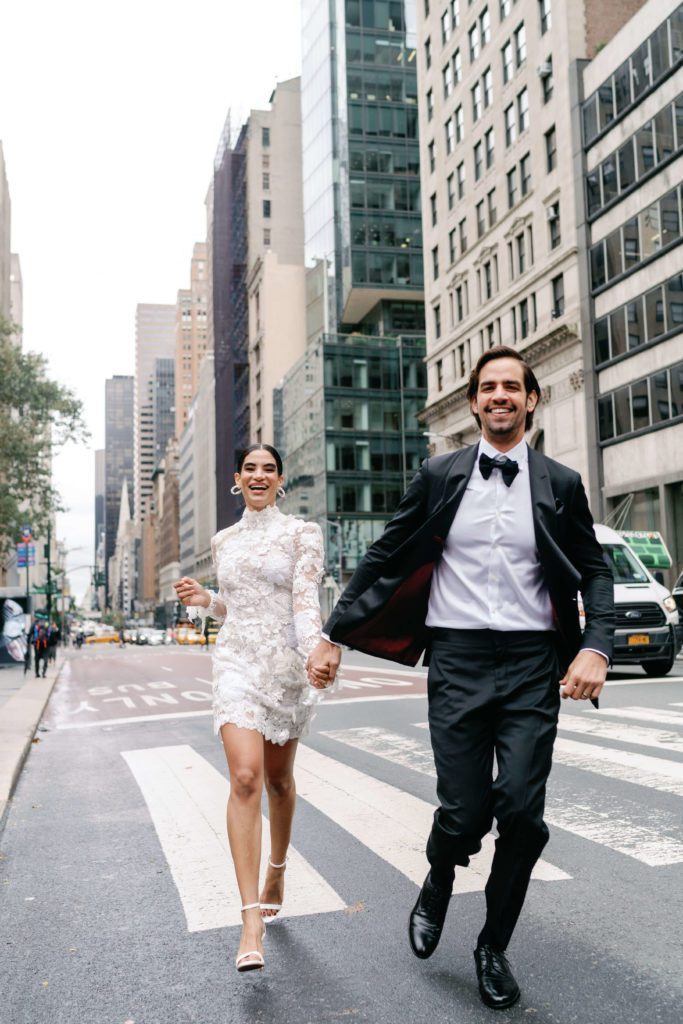 wedding portraits running across fifth avenue in new york city
