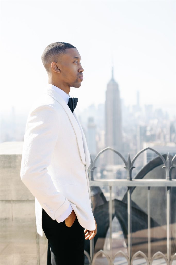 Black groom portrait at top of the rock in new york city