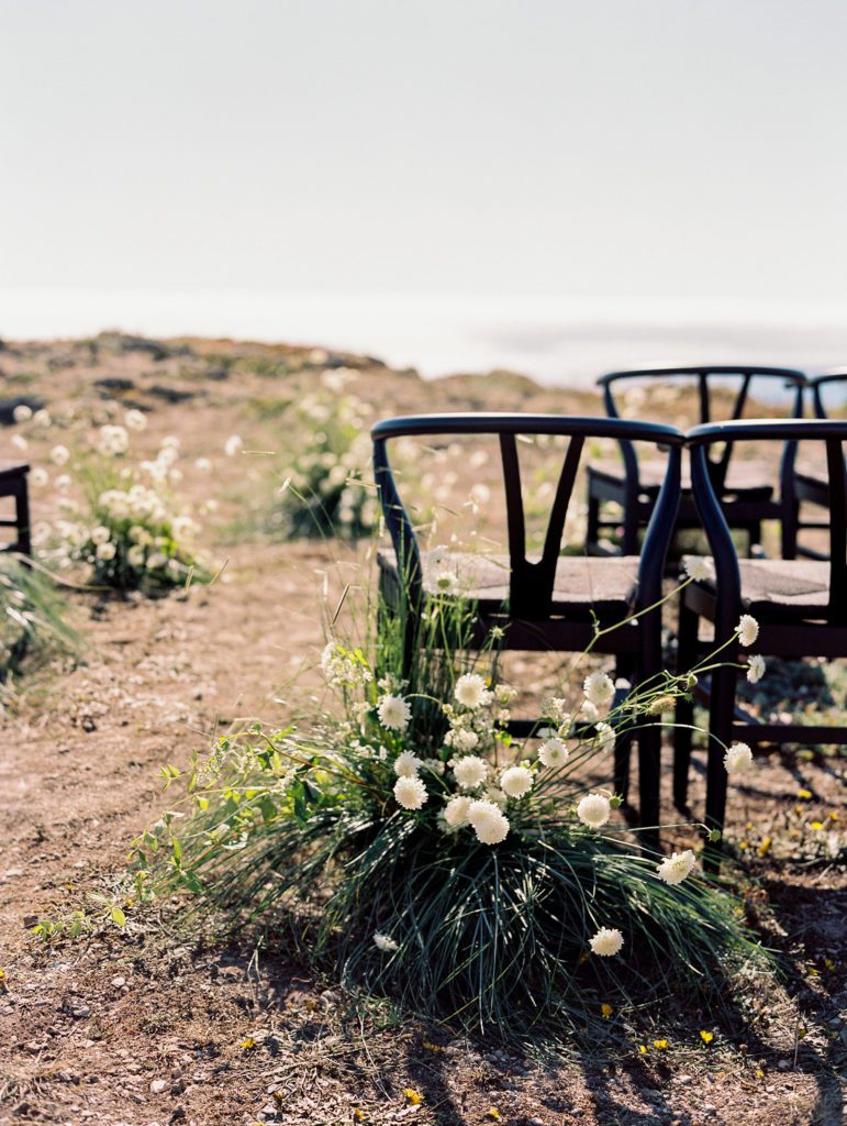 Wedding ceremony with black chairs on the bluff at Sea Ranch Lodge